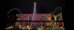 Street view of house with 14 foot light tree. Multicolor.