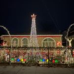 Street view of house with 14 foot light tree. White.