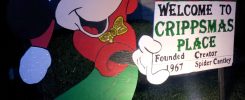 Micky Mouse holding sign "Welcome to Crippsmas Place"